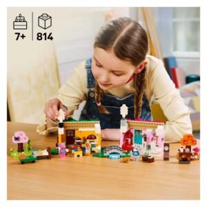 Kind speelt met LEGO Animal Crossing set aan tafel
