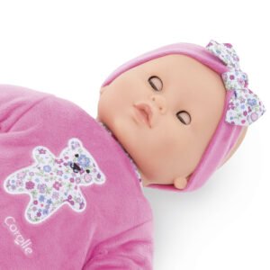 Babypop van Corolle met gesloten ogen en roze haarband