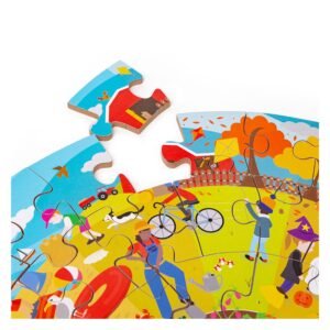 Puzzelstuk met herfstillustratie wordt geplaatst in ronde Bigjigs puzzel