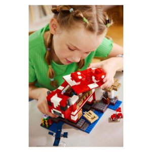 Kind speelt met LEGO Minecraft Mooshroom huis bouwset