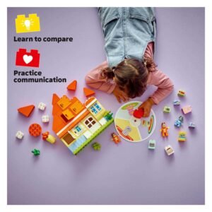 Kind speelt met LEGO DUPLO Bluey huis en draaischijf op paarse ondergrond