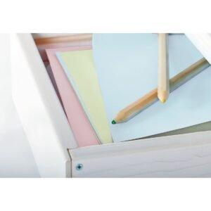 Pastelkleurig papier en kleurpotloden in lade van kinderbureau