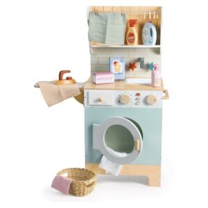 Houten speelgoed wasmachine met accessoires en mand in minimalistische studio setting