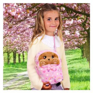 Meisje draagt interactieve knuffelhond in roze draagzak